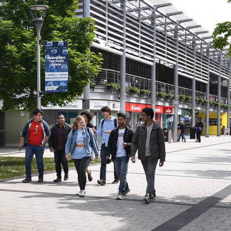 Current ӲƵ students walking through the campus